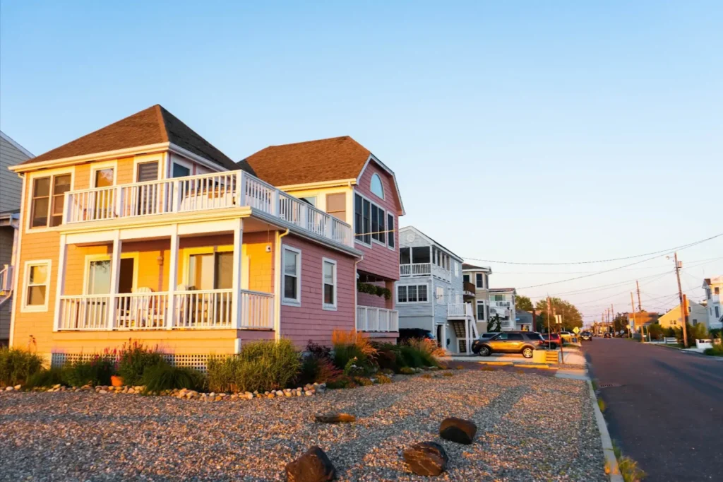 A beachside street with houses at sunset. 