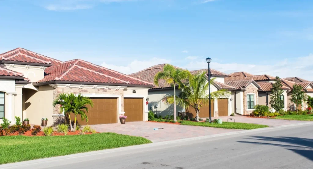 A luxurious neighborhood in Florida featuring large homes and palm trees.
